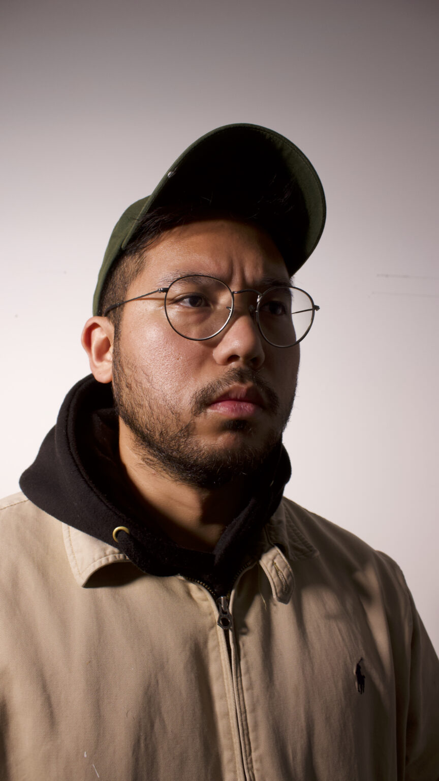 A portrait of a person against a light backdrop.
