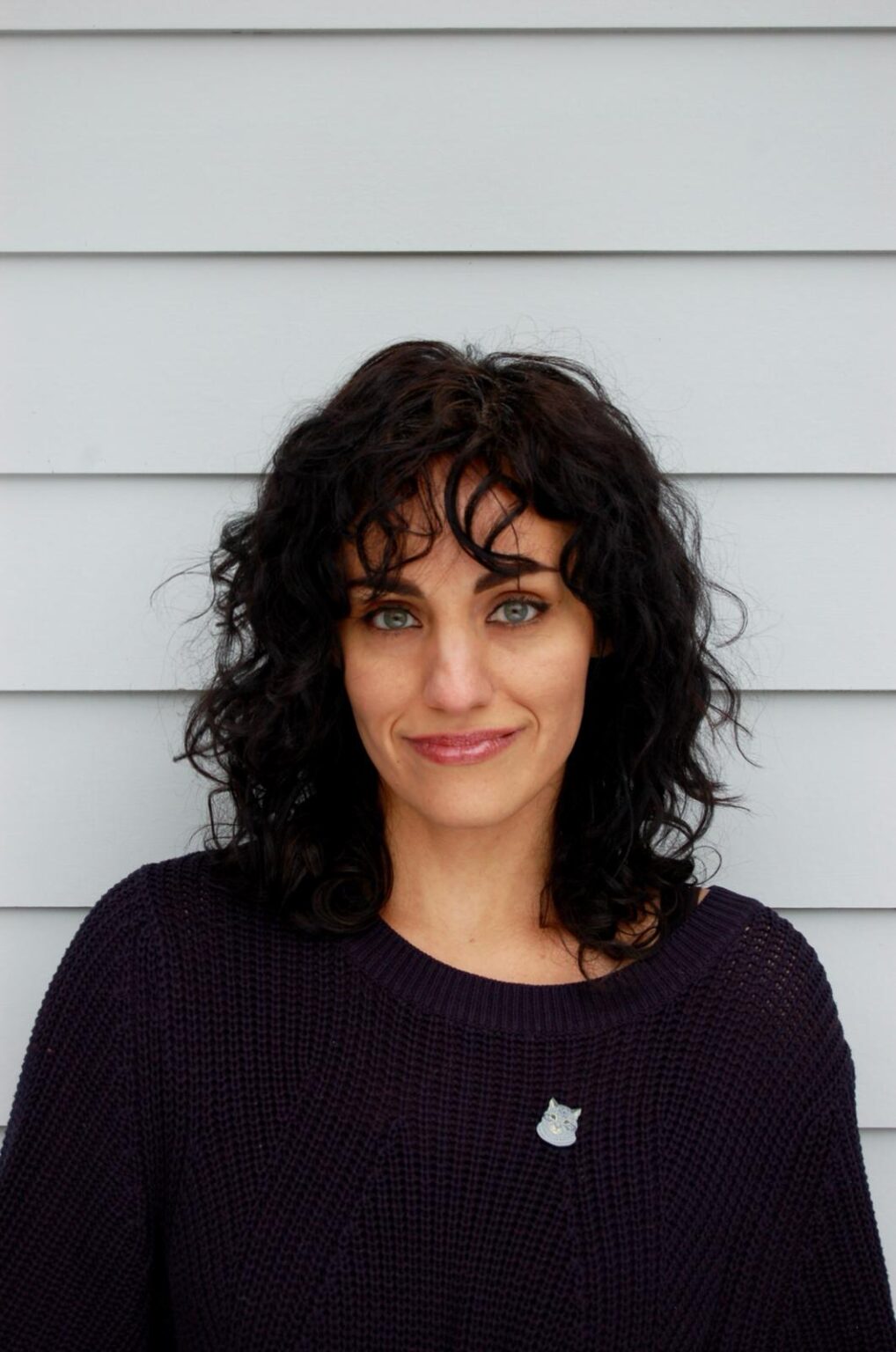 A portrait of a person against a light background.