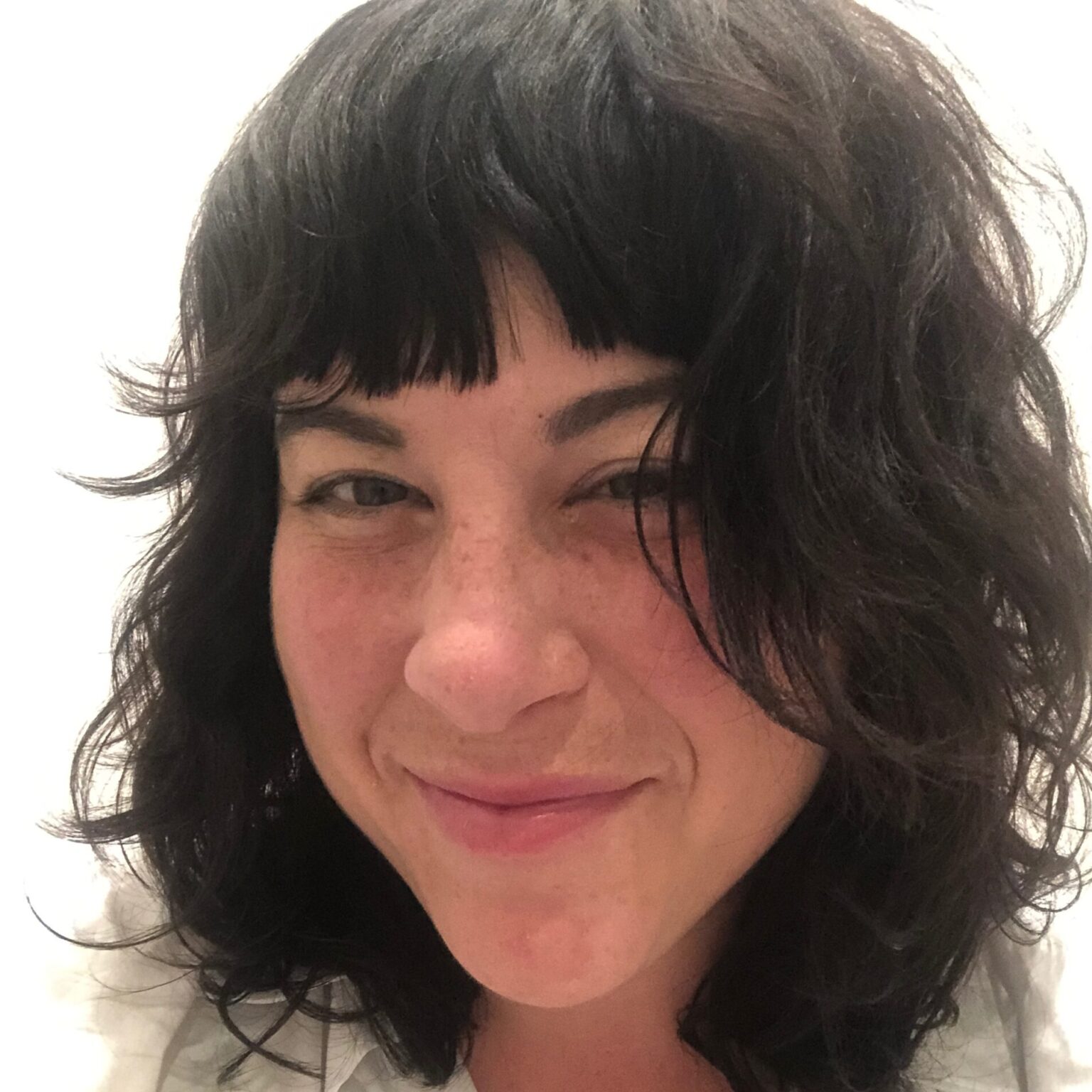 A portrait of a person against a light background.