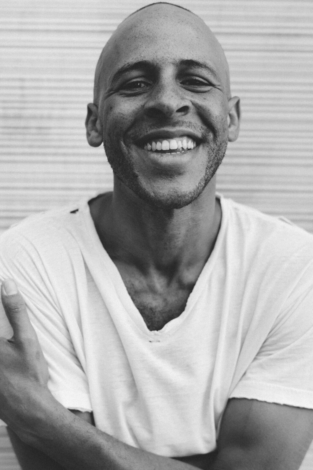 A portrait of a person against a striped background.