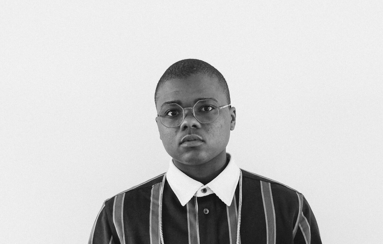 A portrait of a person against a light background.