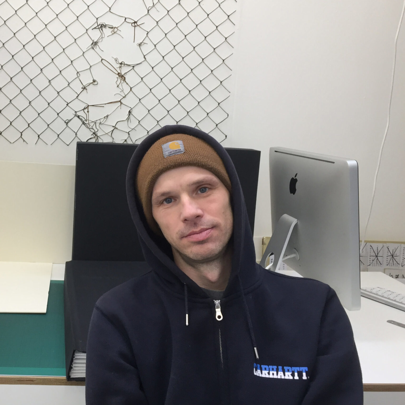 Person in a hoodie at a desk