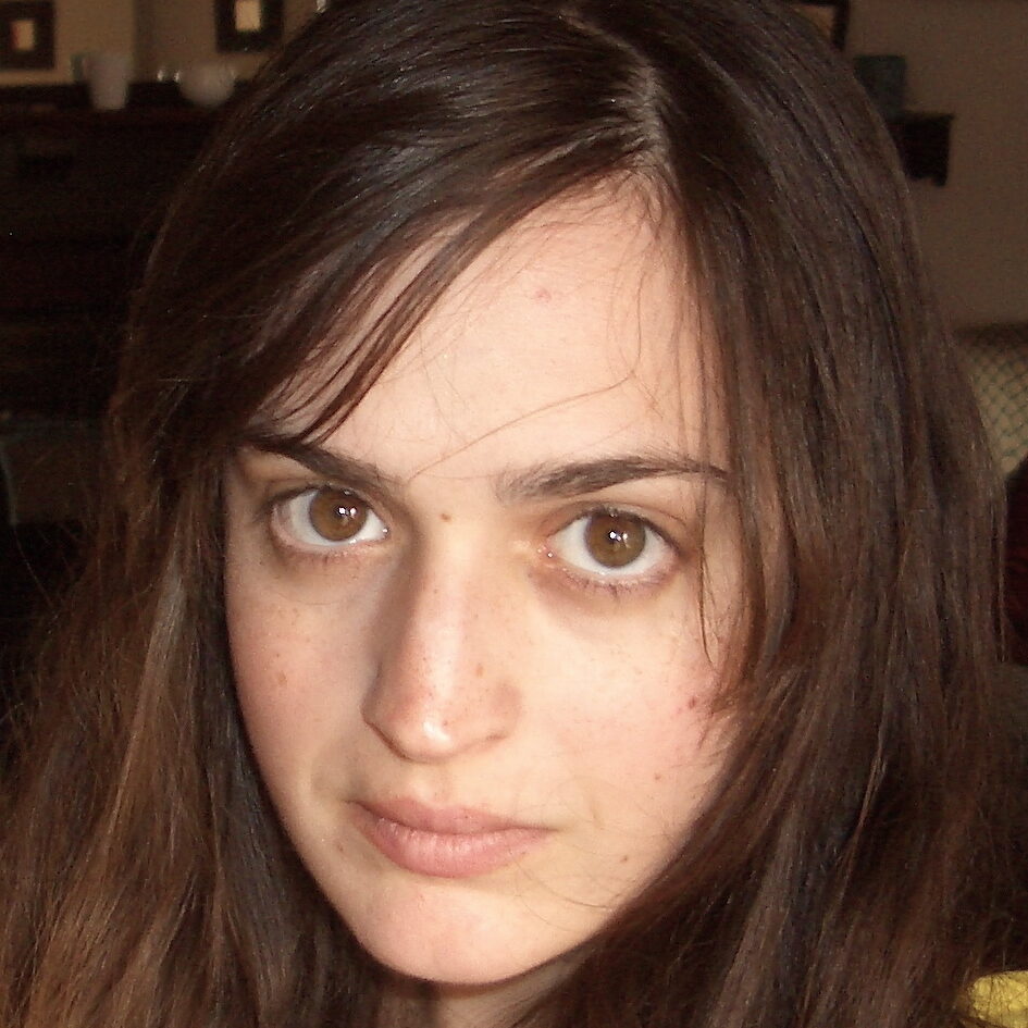 A portrait of a person in a furnished room.