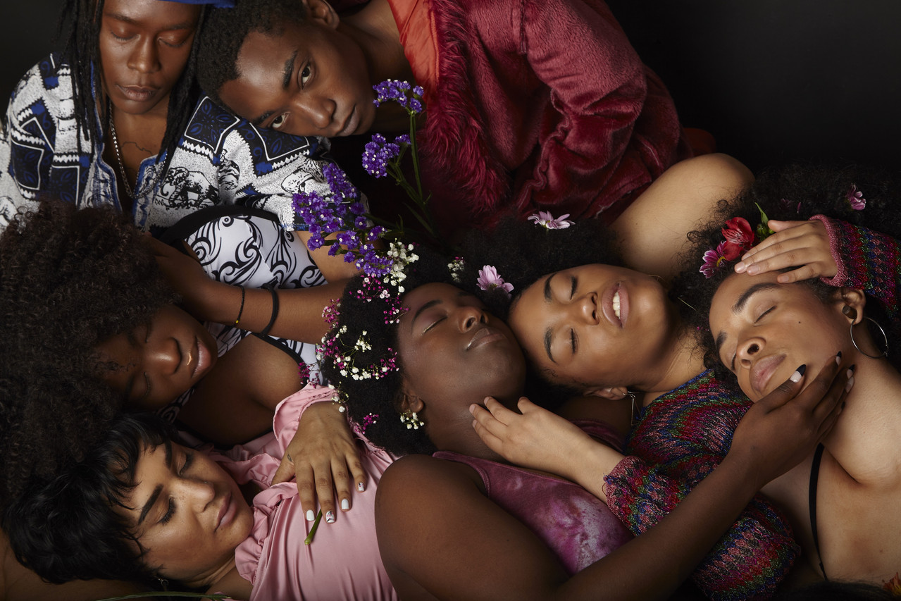 A group of people's faces grouped together with eyes closed.