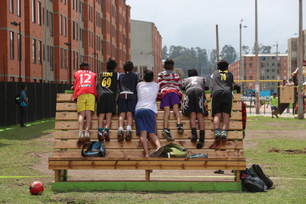 A group of kids climbing on a structure.