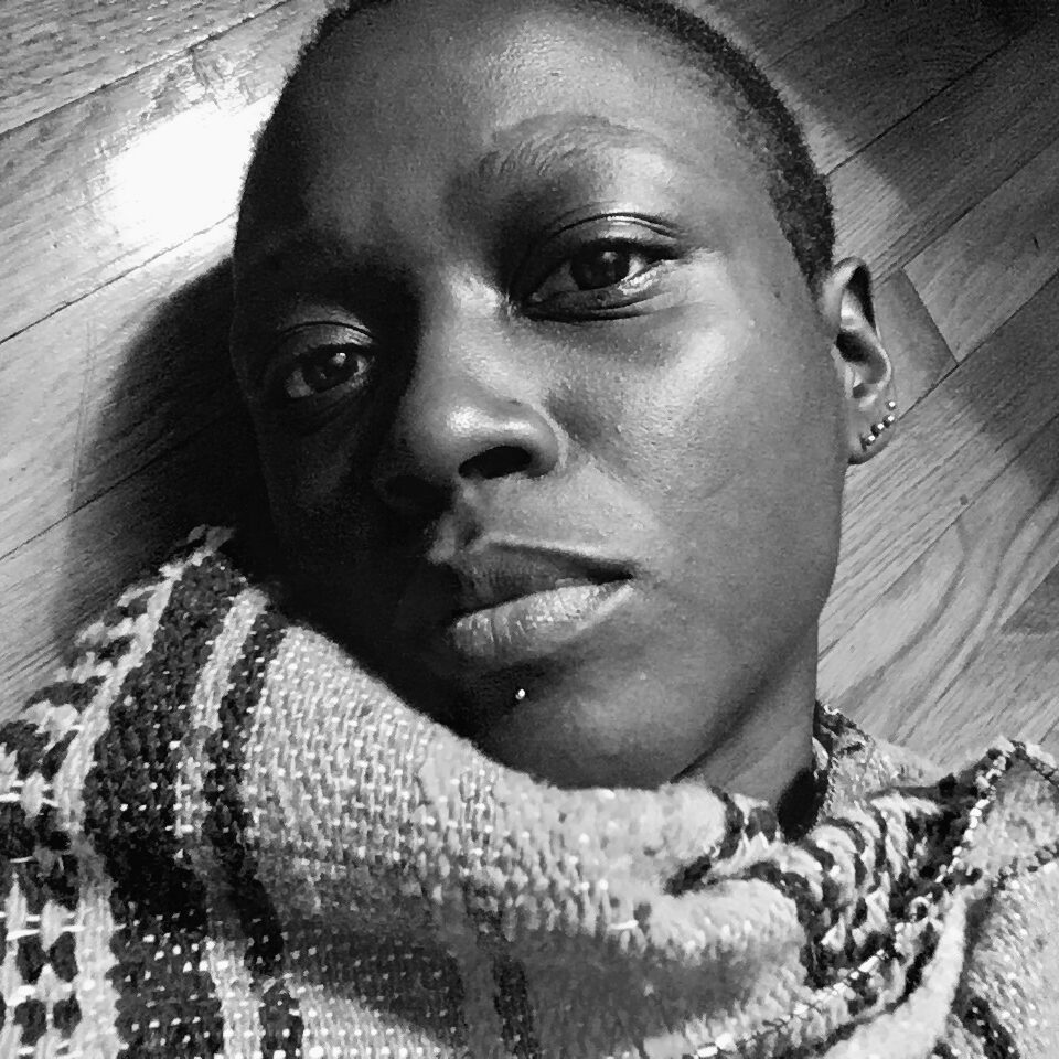 A portrait of a person against a background of hardwood planks.