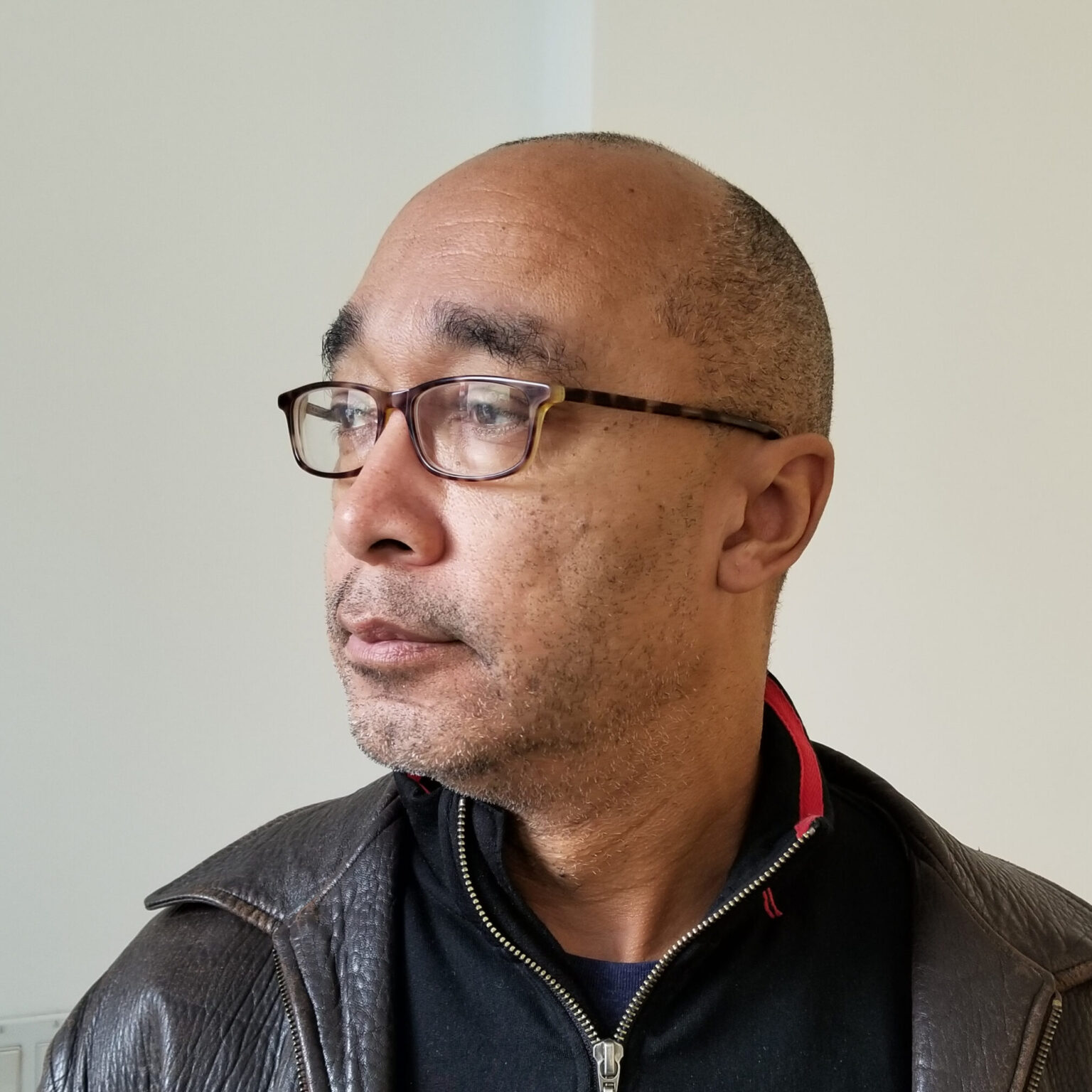 A portrait of a person against a light background.