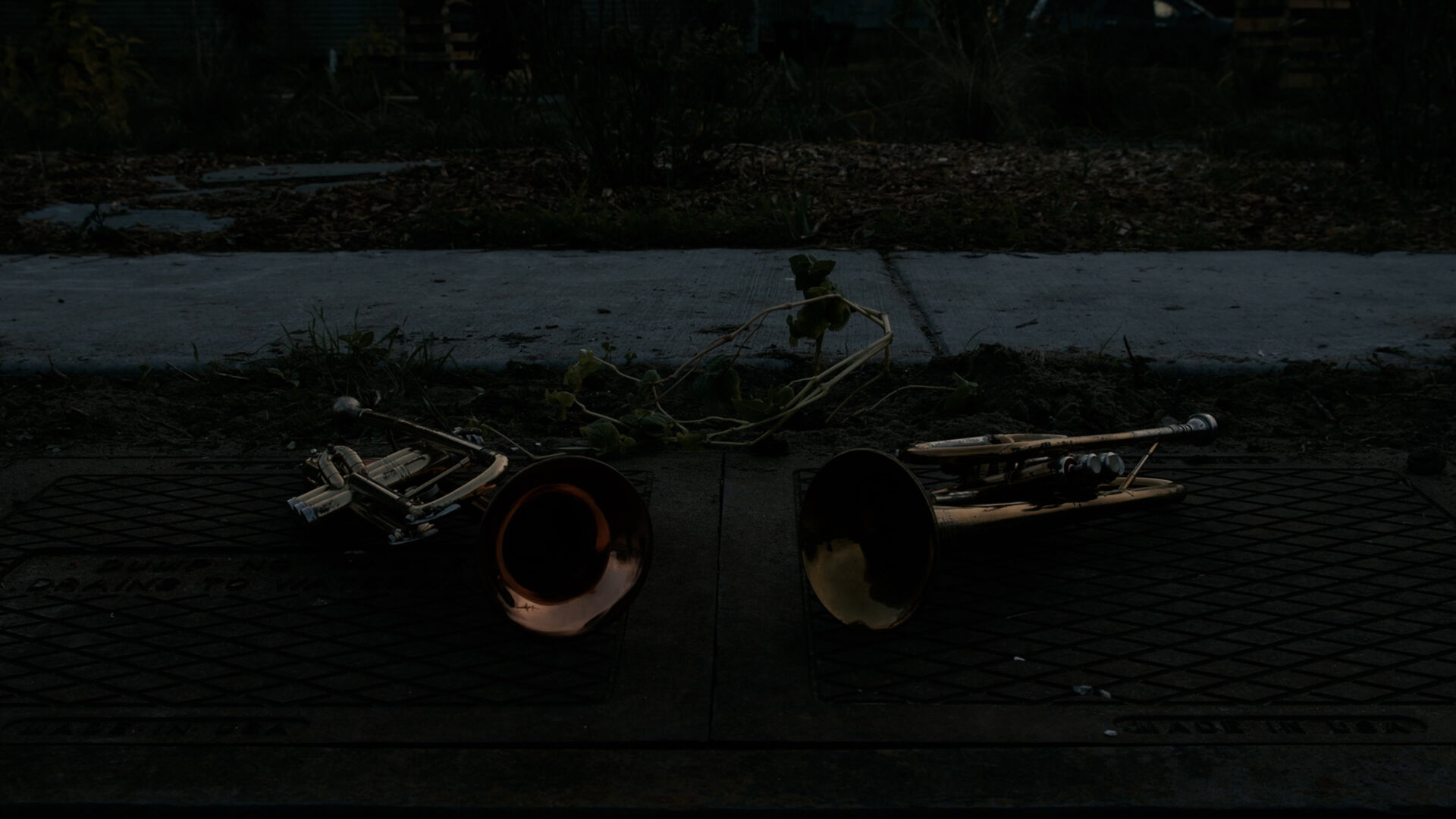 brass trumpets on the ground in the dark
