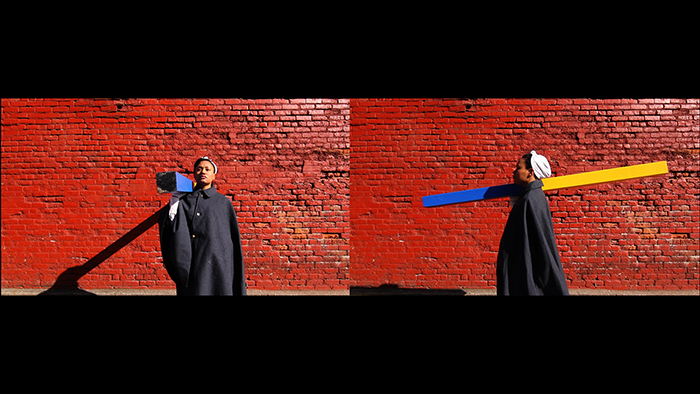 Two images side-by-side of a person holding a yellow and blue post against a red wall.