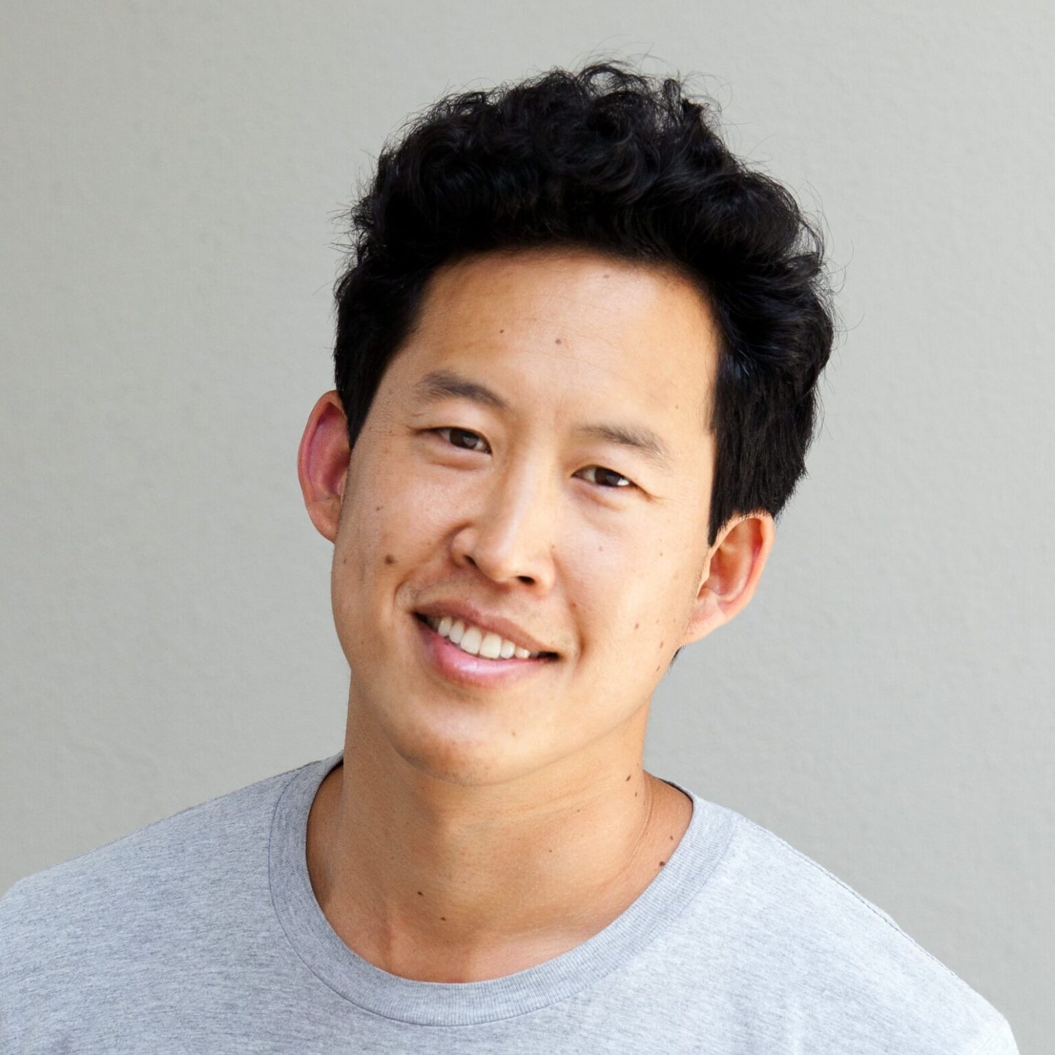 A portrait of a person against a light background.