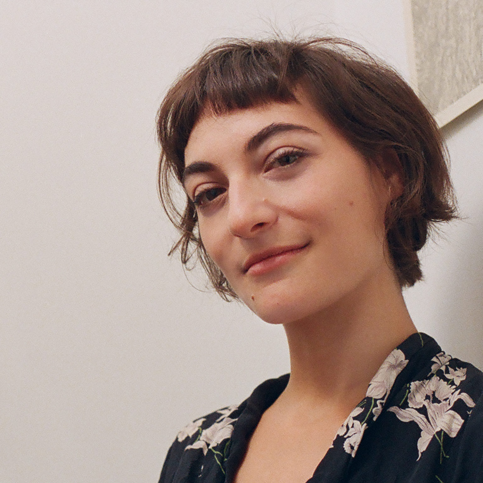 A portrait of a person against a white background.