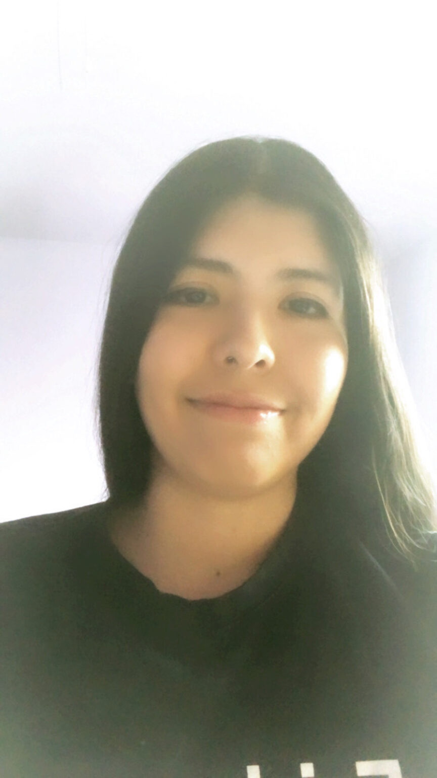 A portrait of a person against a light background.