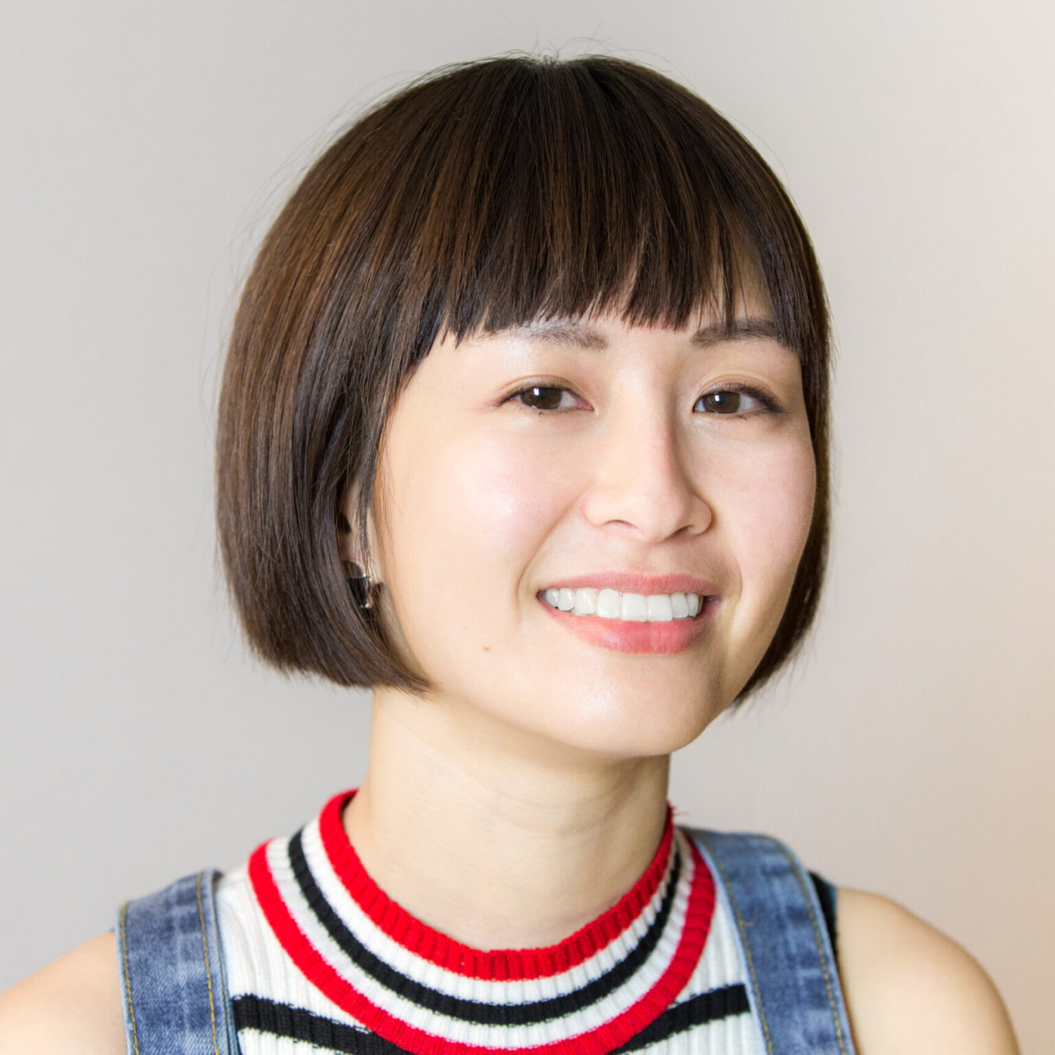 A portrait of a person against a light background.