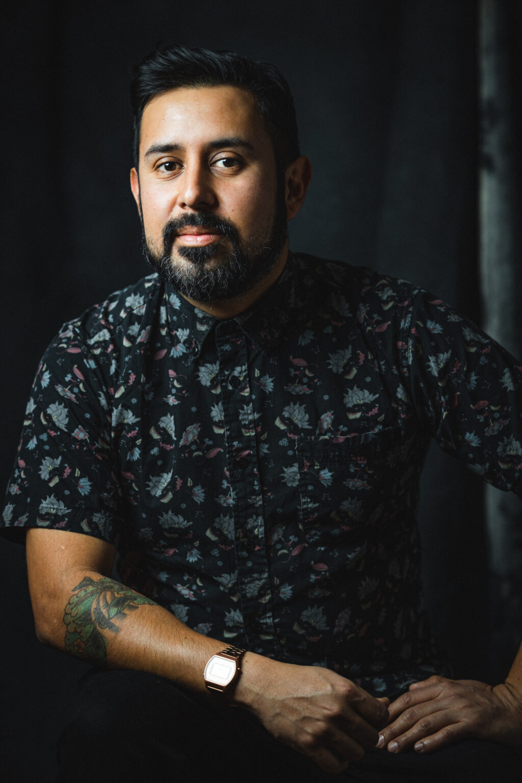 A portrait of a person against a dark background.