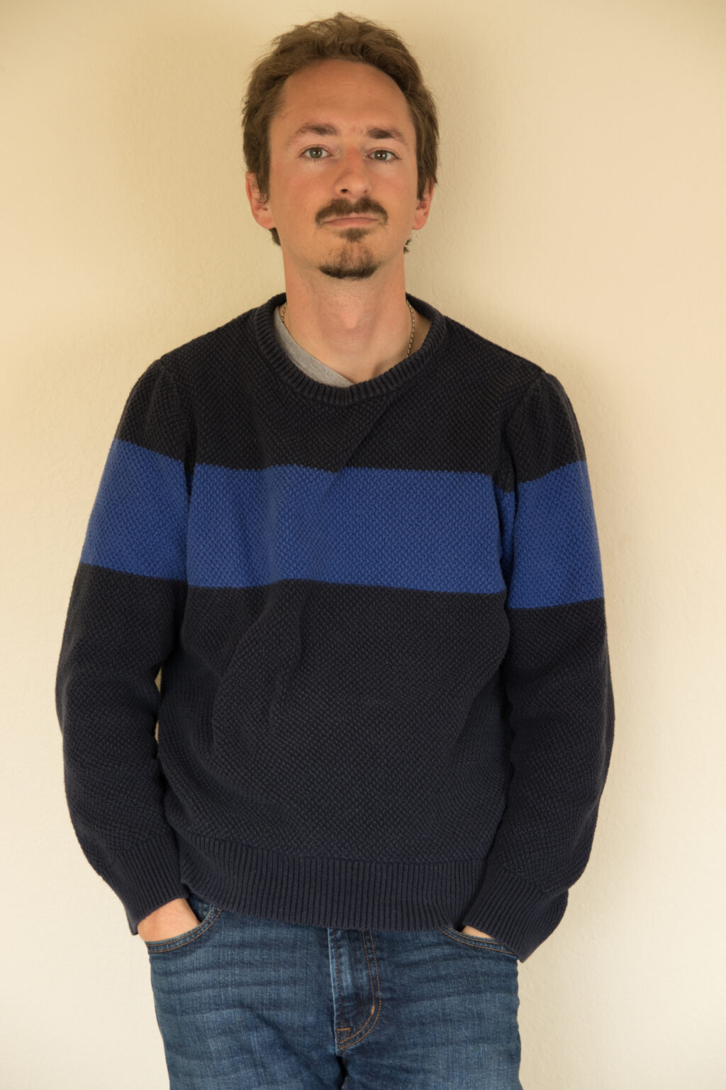 Person standing against wall.