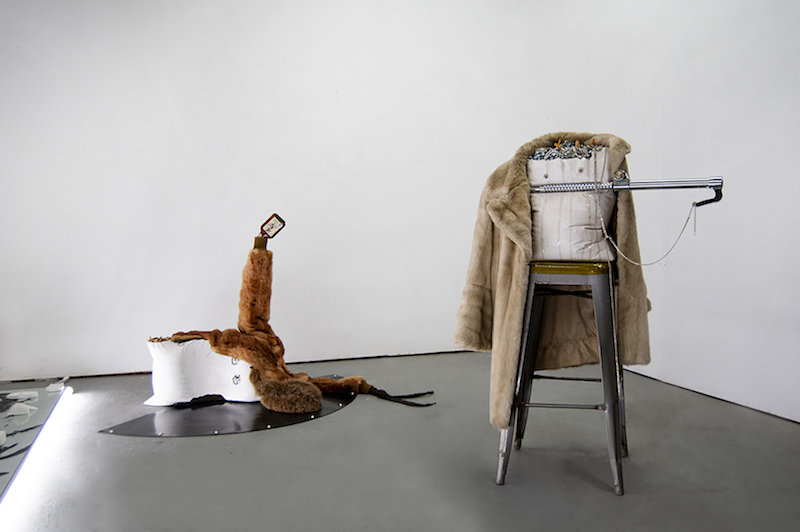 Sculpture with stools and fur coats