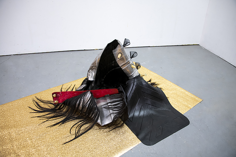 Black and red sculpture on the floor
