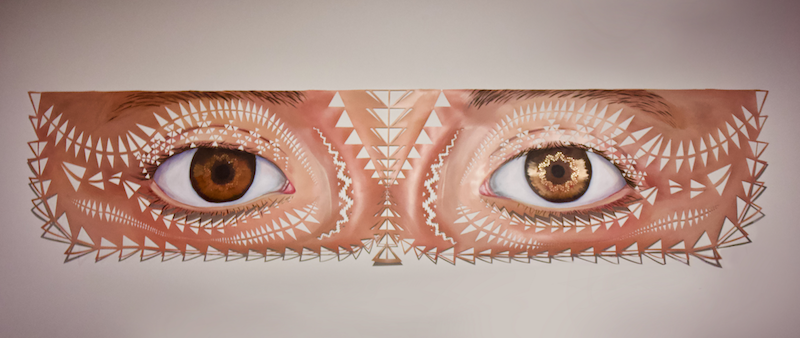 Painting of eyes, with triangle patterned cutouts