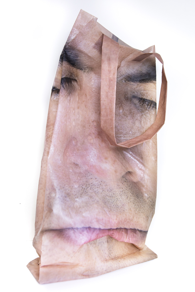 fabric bag with handle, printed with an image of a face