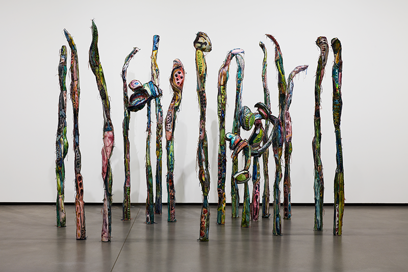 A group of colorful sculptural forms resembling freestanding vertical sticks.