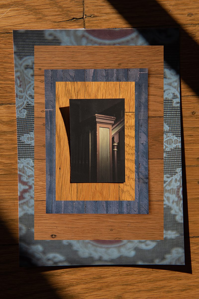 Collaged photographs arranged in concentric rectangles with a photo of a stair banister at center, and alternating bands of warm woodgrain and cool wood and textile.