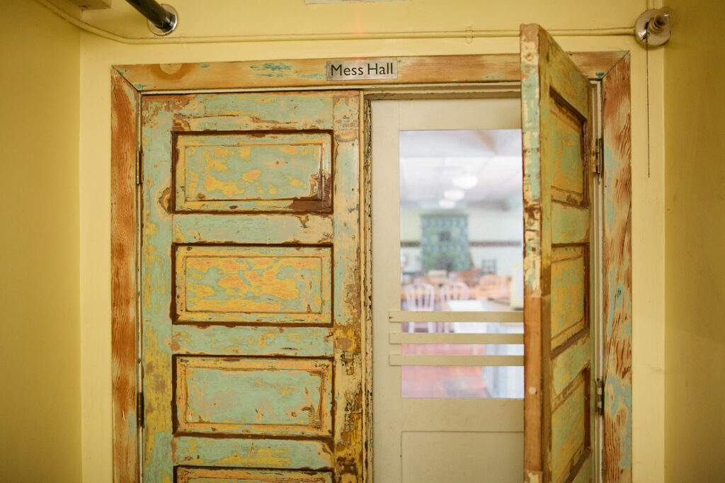 A large green door opening onto a large room