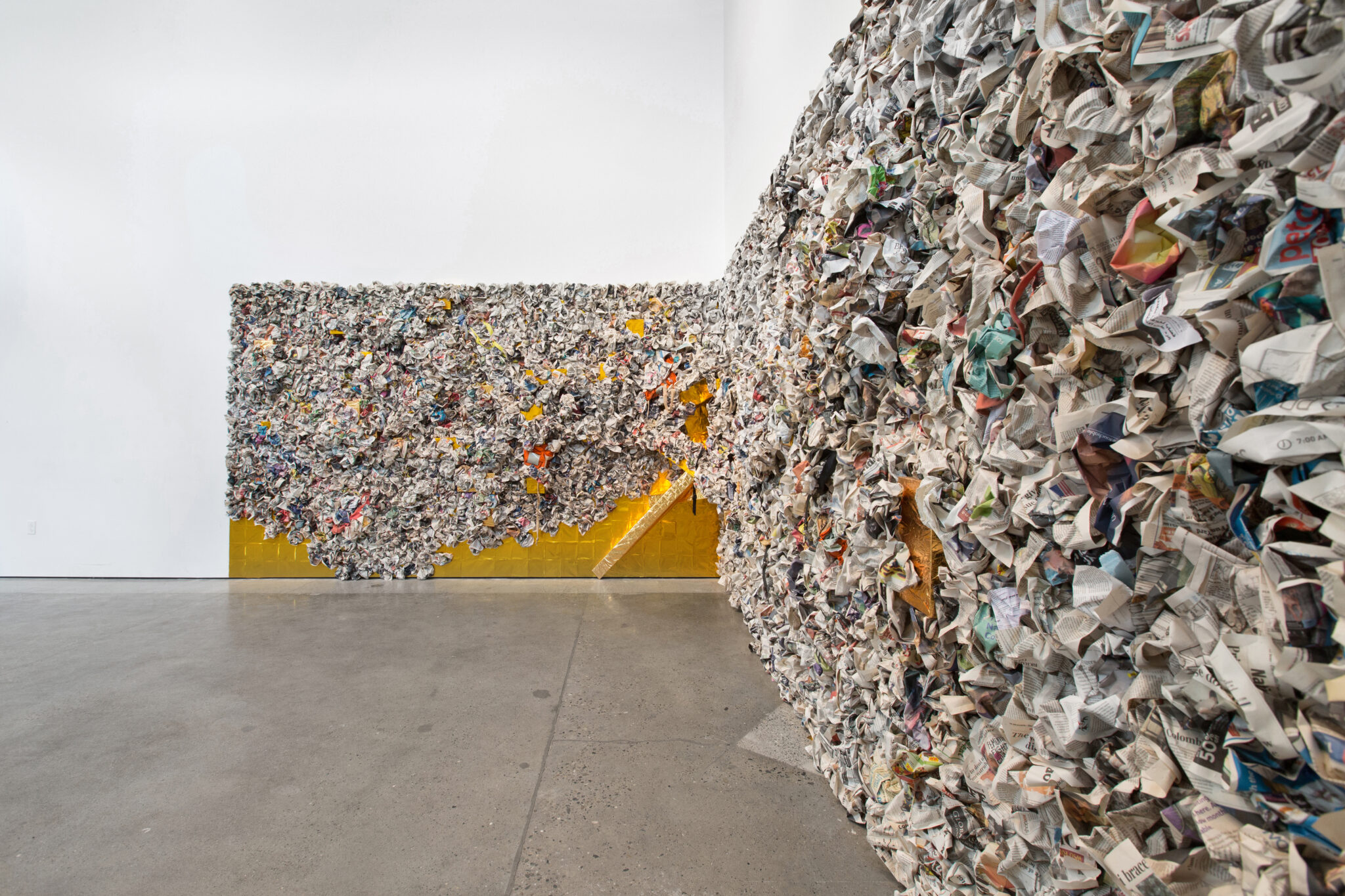 corner wall filled with crumpled newsprint