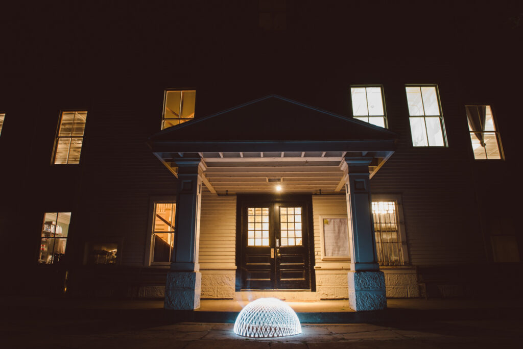 A glowing orb in front of a building