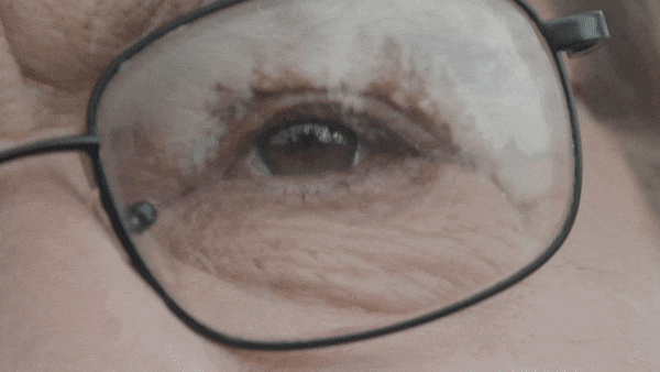 gif of image reflecting off of a persons eyeglasses