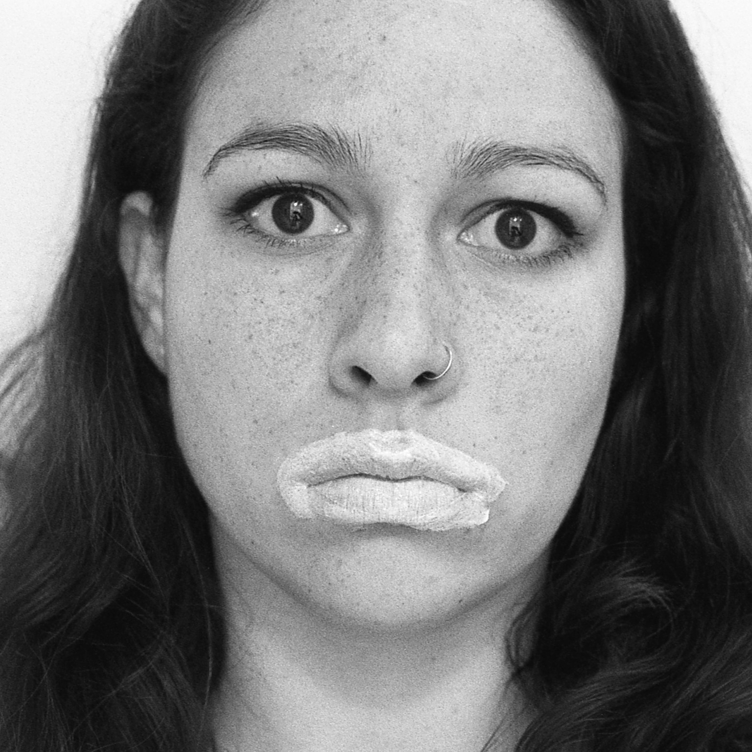 Portrait of Jane Marchant with white paint on her lips.