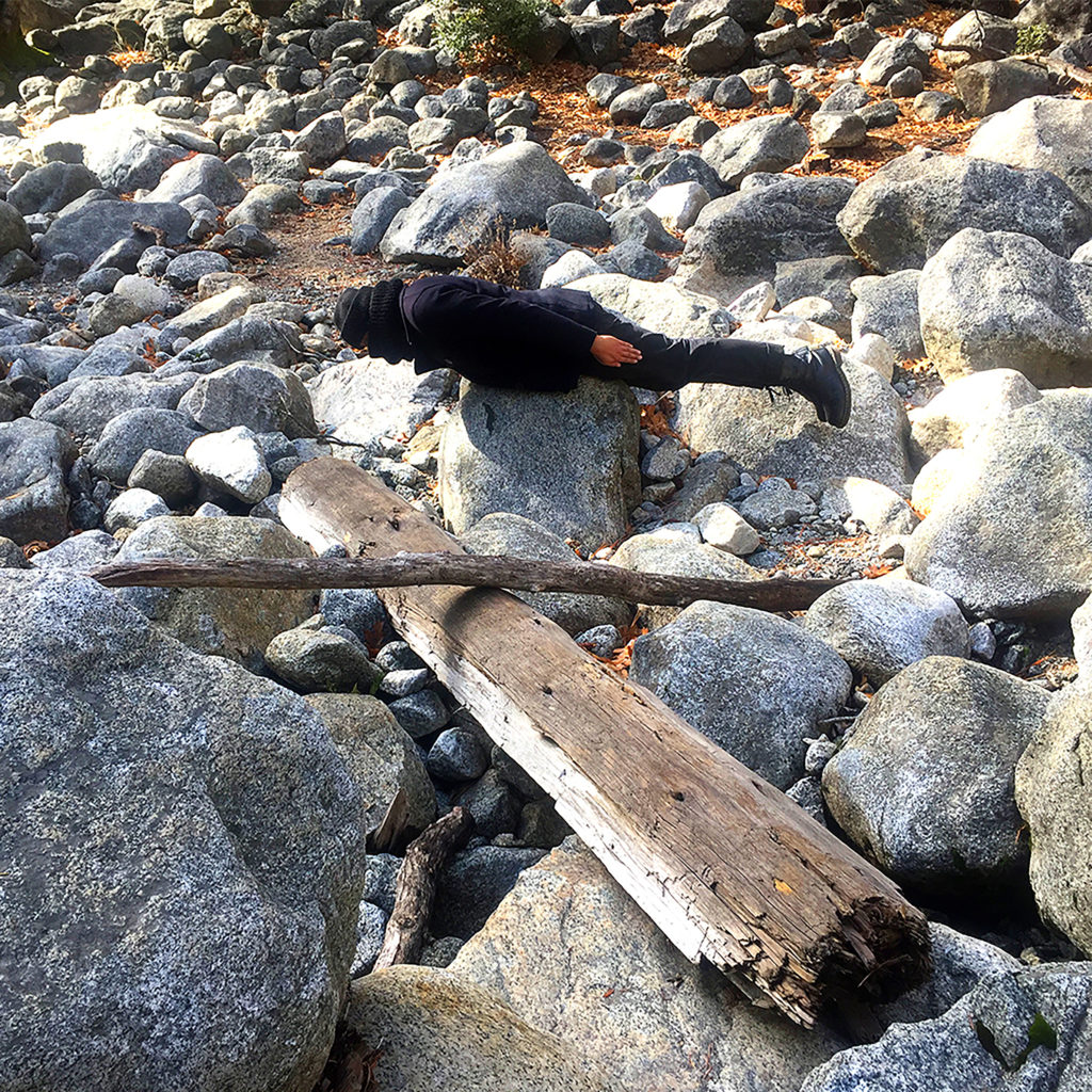 A photo of a person balancing on a rock