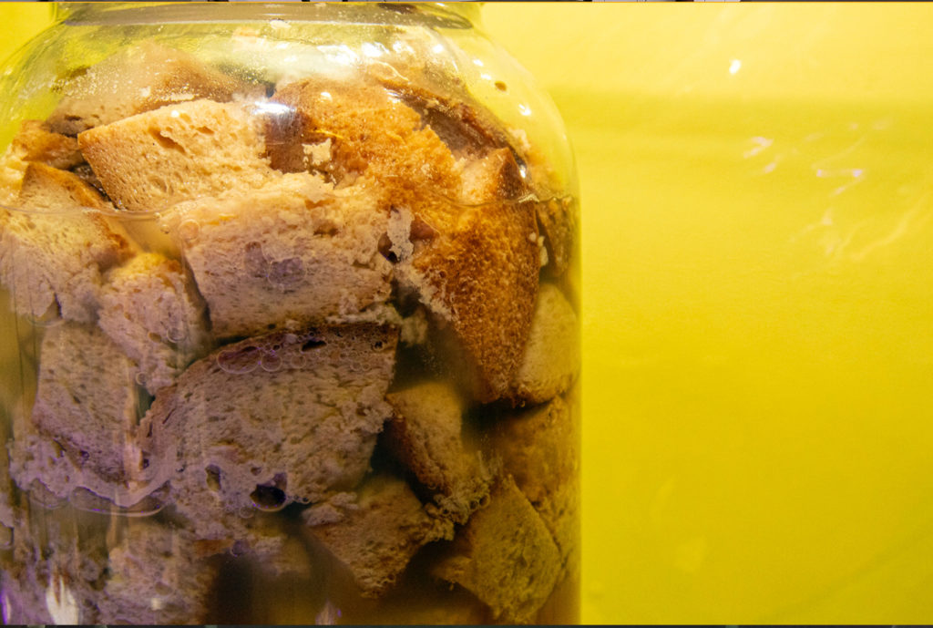 A jar of bread photographed against a yellow ground
