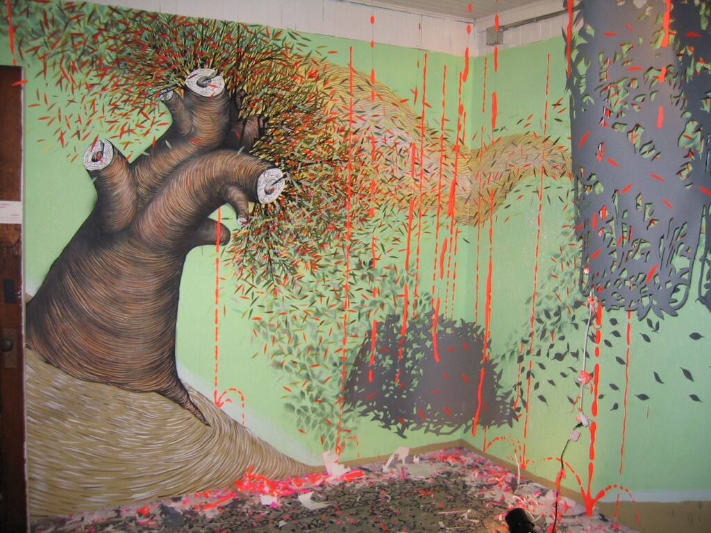 An installation with hanging paper and murals of a strange tree