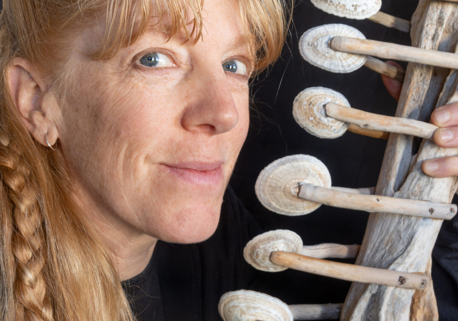 Portrait of Cheryl Leonard with an instrument made of shells