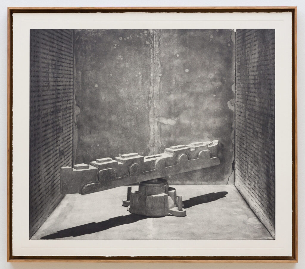 A framed black and white image of a sculptural work