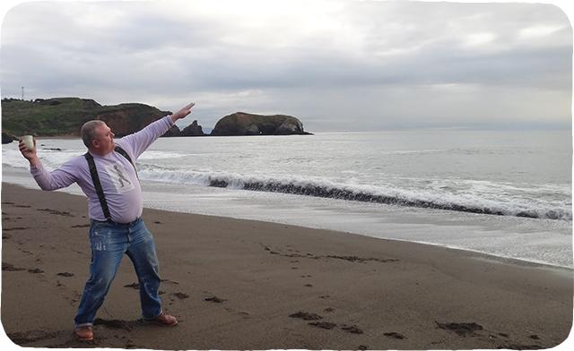 Ehren Tool throwing a cup into the ocean