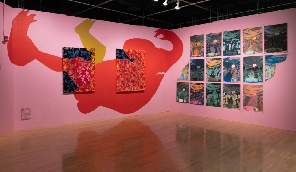 Installation featuring works on a wall and painted wall with red figurative shape
