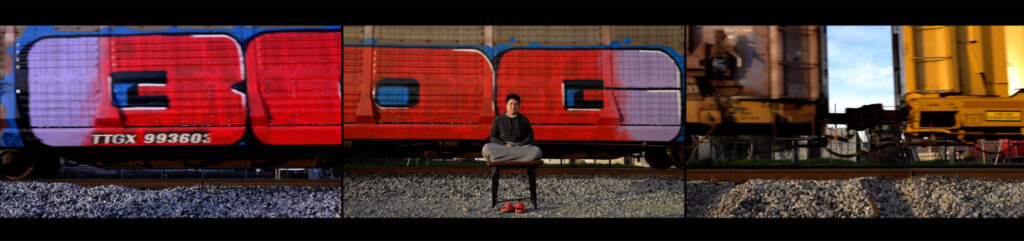 Photo of a person sitting in meditation in front of colorful trains