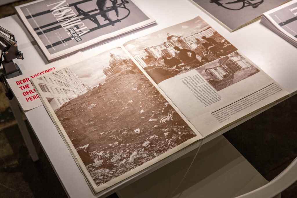 An open booklet on a desk with photographs