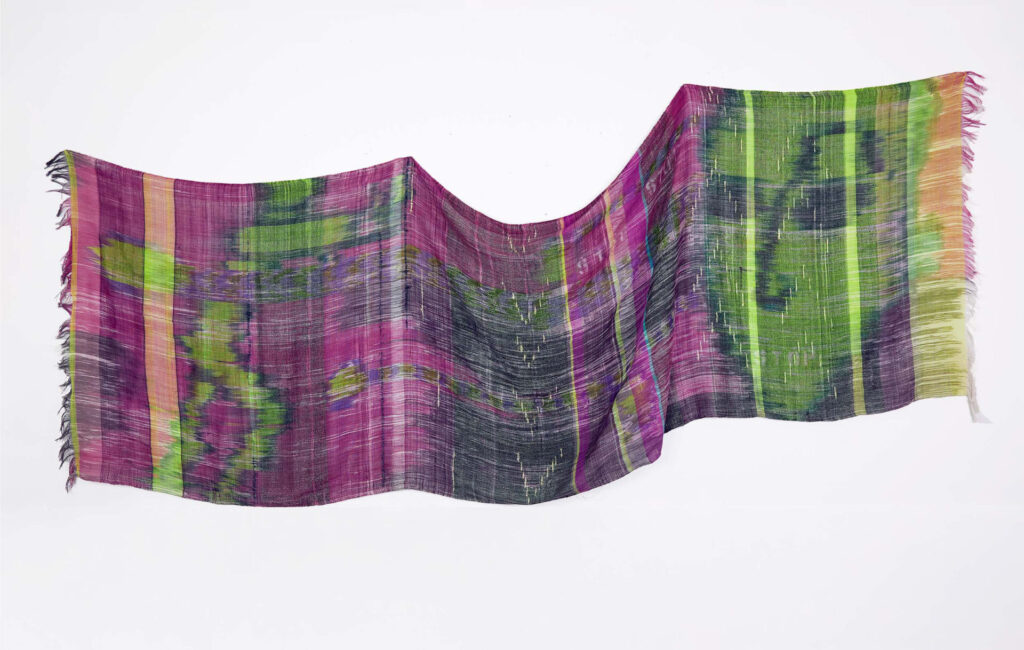 A woven textile in shades of purple and green