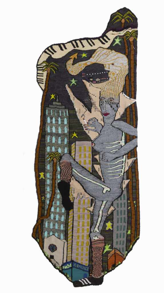 A woven tapestry with an image of a figure towering over buildings