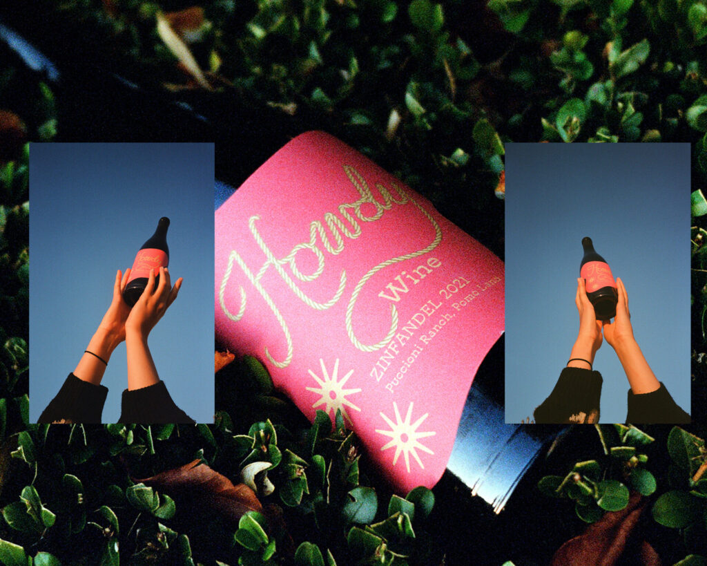 A bottle of wine with a pink and gold label